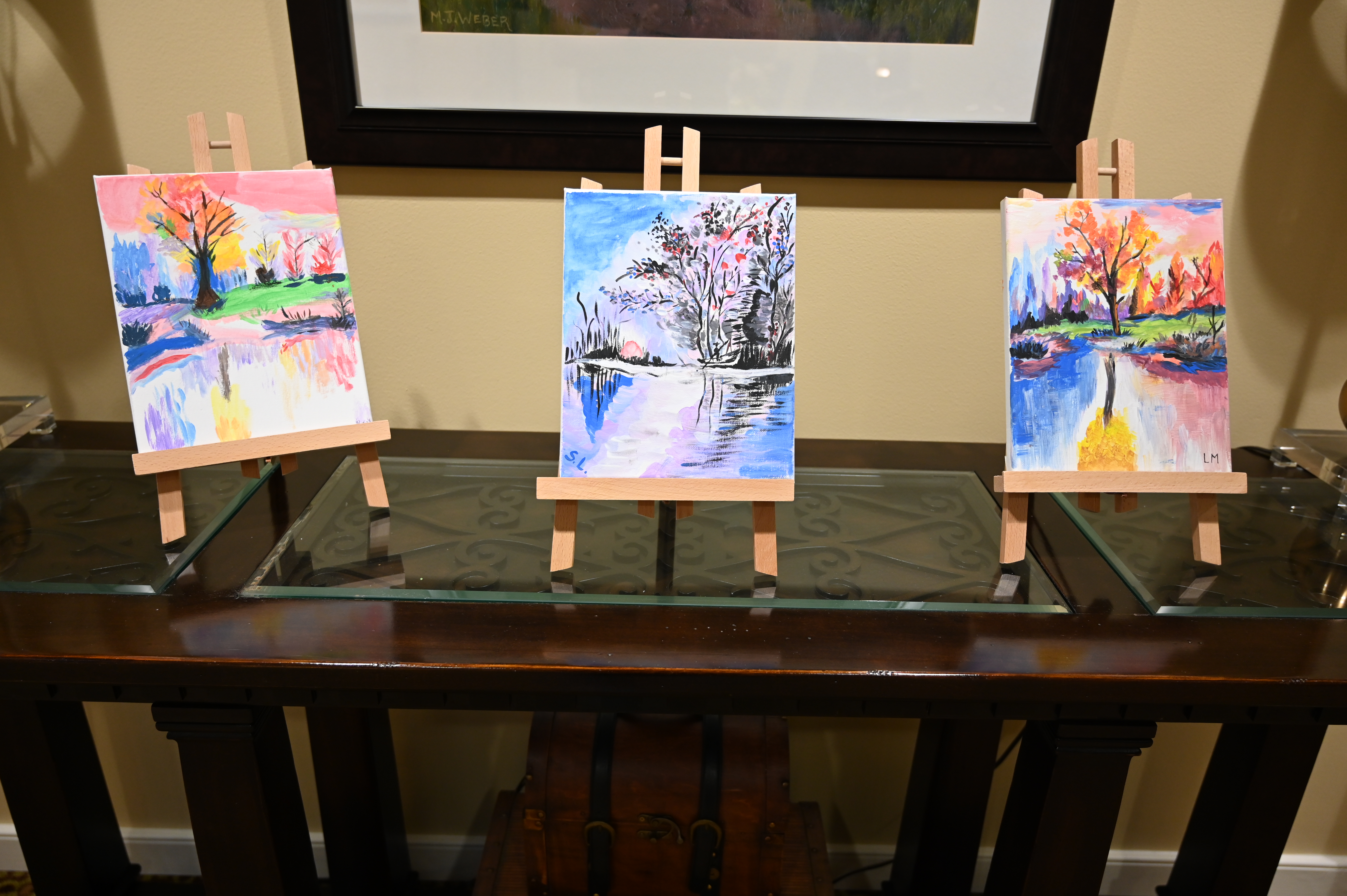 Three paintings by residents at Brightview Mays Chapel Ridge